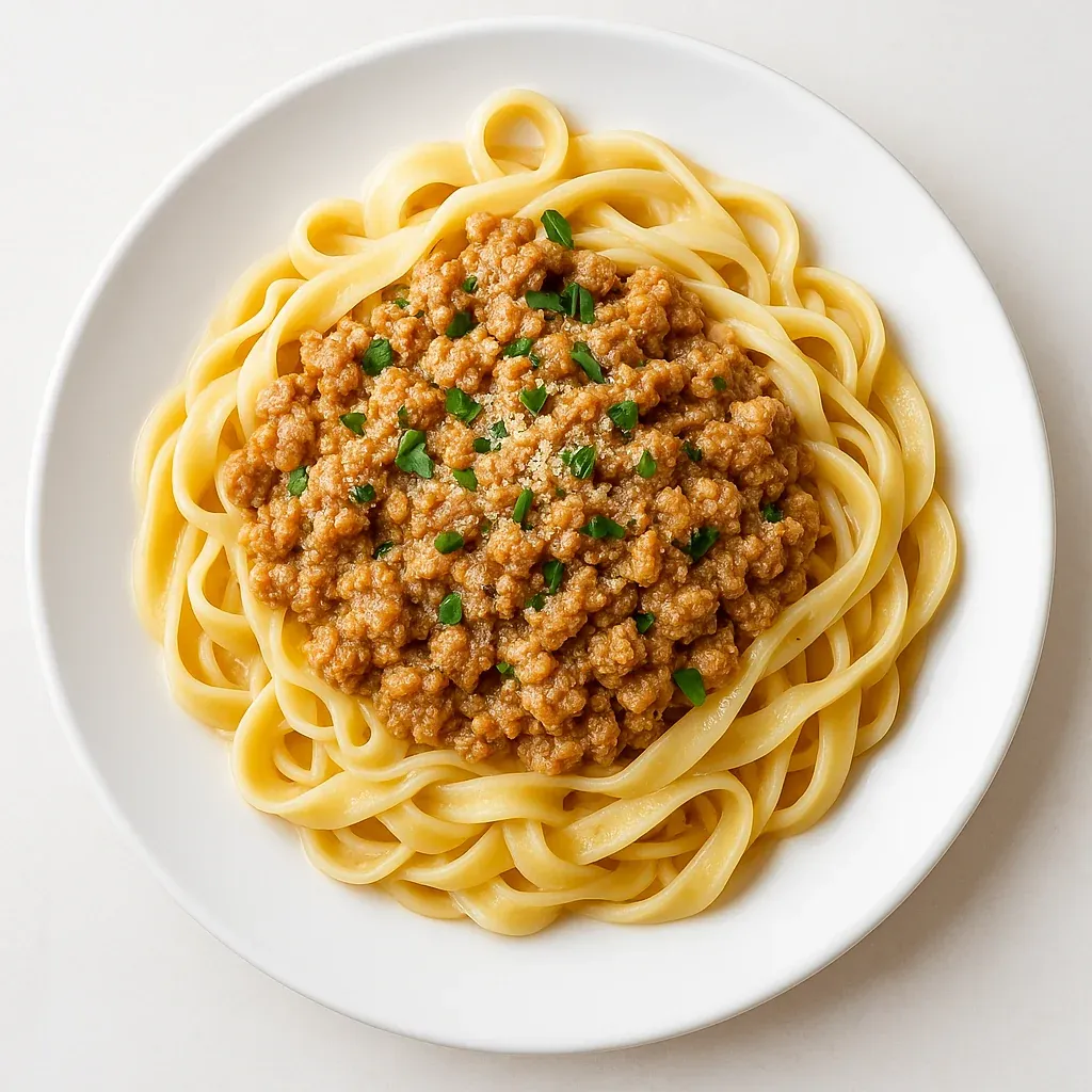 A plate of pasta with meat sauce.