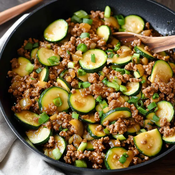 A colorful plate with cooked turkey and zucchini.
