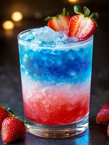 A glass of red, white and blue drink.