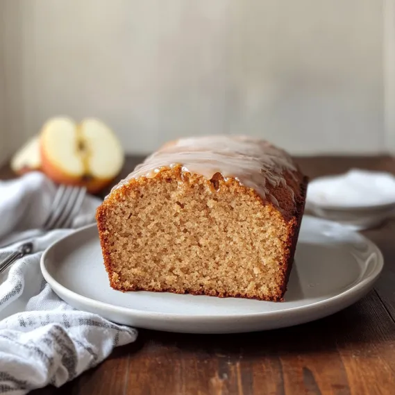 A slice of cake drizzled with cinnamon glaze.