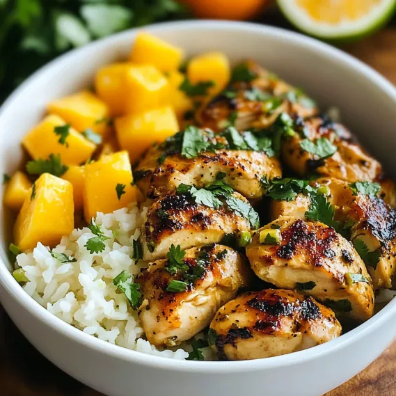 A colorful dish with chicken, rice, and pineapple chunks.