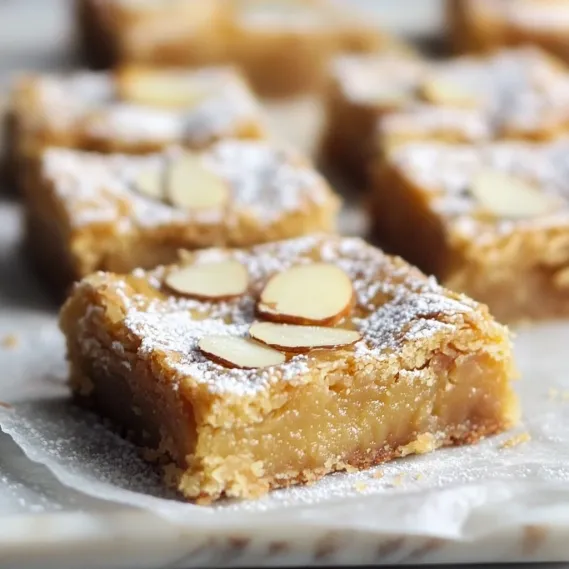 A blondie square topped with almonds.