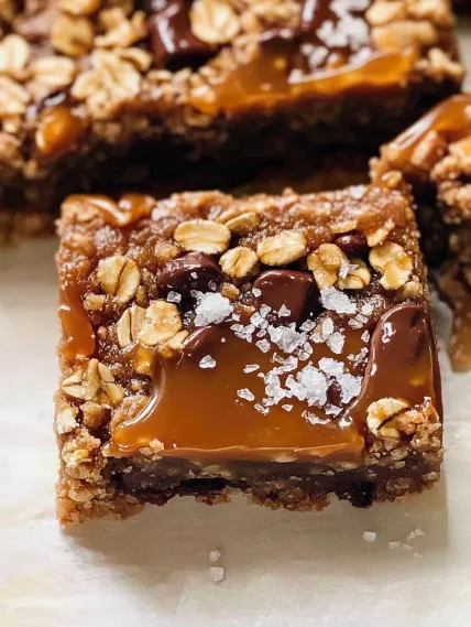 A piece of chocolate cake with nuts on top.