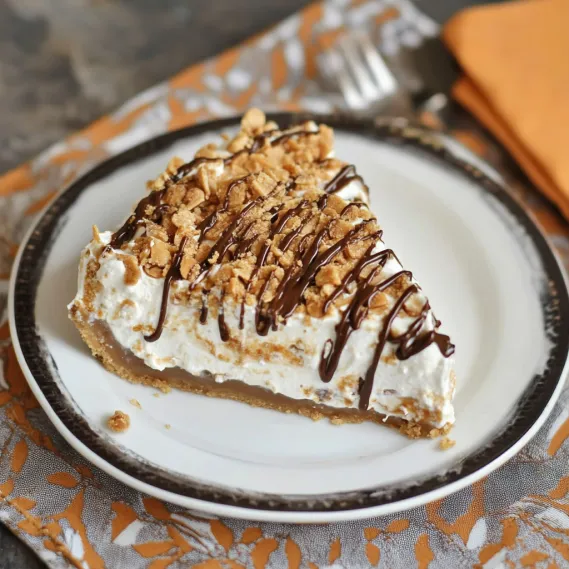 A slice of pie topped with drizzles of chocolate and caramel.