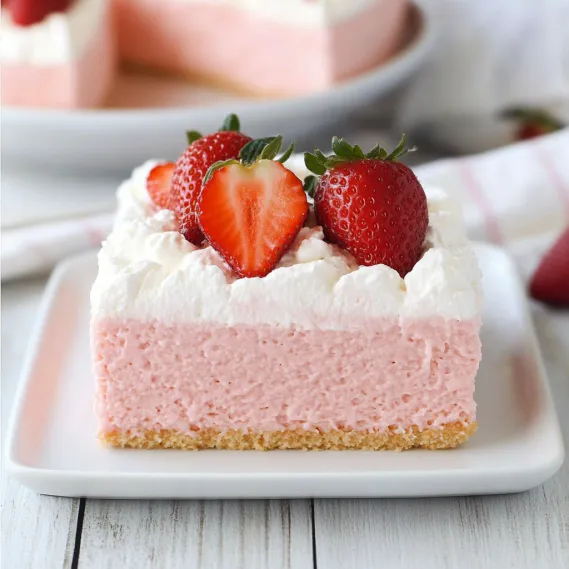 A slice of cake topped with strawberries.