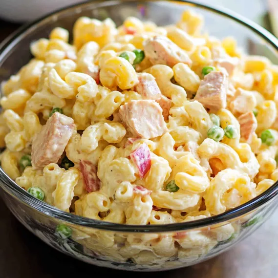 A bowl filled with creamy pasta and toppings.