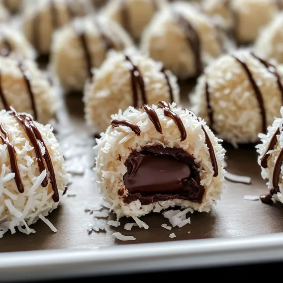 A plate filled with chocolate-covered coconut treats.
