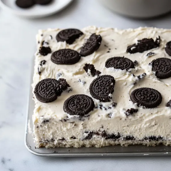 A piece of cake with creamy Oreo topping.