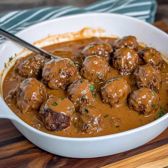 A serving of juicy meatballs in mushroom gravy.