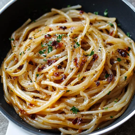 A serving of pasta with fresh herbs and cheese.