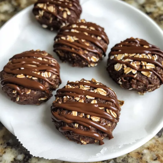 A plate piled with chocolate-coated cookies.