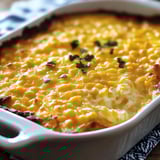Corn casserole served in a white dish.