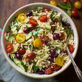 A fresh mix of pasta and colorful vegetables in a bowl.